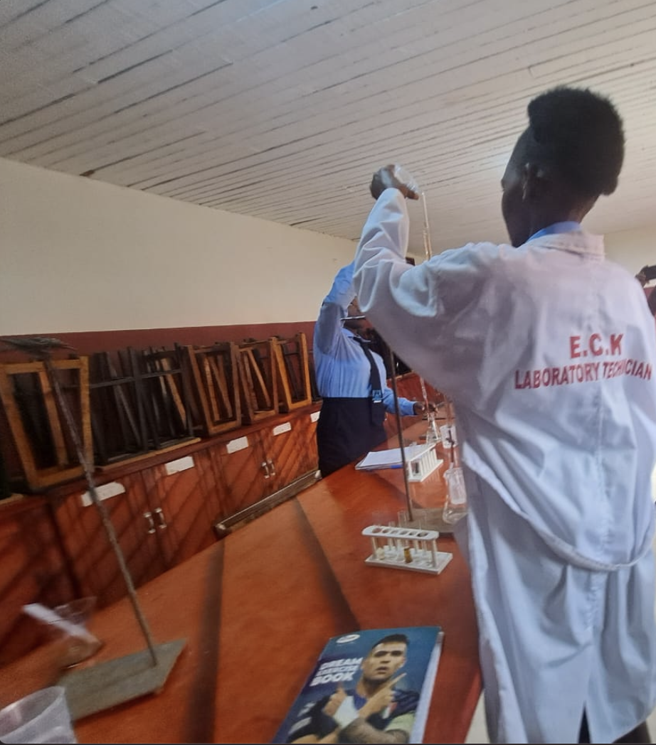 Laboratory technician supervising chemistry class.